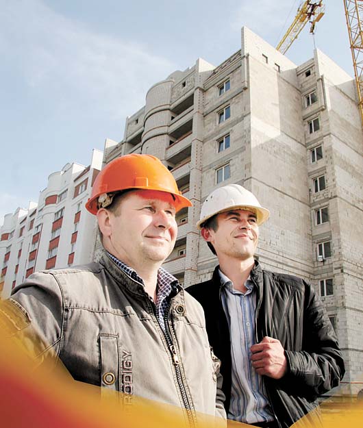 Мастер Дмитрий Бобков и прораб Юрий Авижиц возле многоэтажного жилого дома, который возводят жлобинские строители